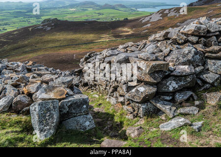 Tre`r Ceiri Hillfort and Yr Eifl showing stone huts, North Wales, UK Stock Photo